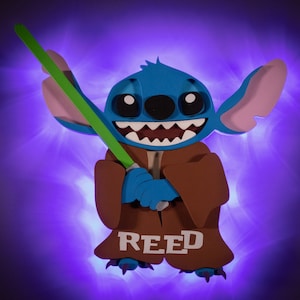 May include: A blue Stitch character holding a green lightsaber, wearing a brown robe with the name "REED" written on it. The character is illuminated with a purple light.