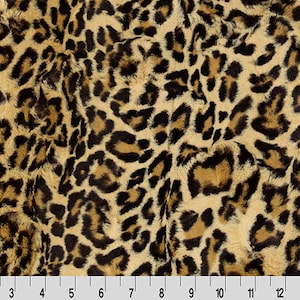 May include: A close-up of a brown and black faux fur fabric with a leopard print pattern.