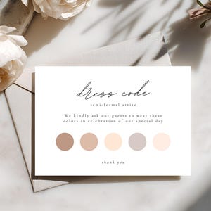 May include: A white card with the words "dress code" and "semi-formal attire" in elegant script. The card includes a colour palette of neutral tones and the text "We kindly ask our guests to wear these colours in celebration of our special day."