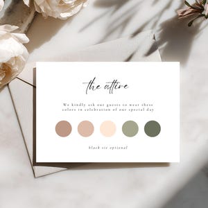 May include: A white card with the text "the attire" in elegant script, accompanied by a color palette of brown, beige, and green. The card also includes the text "We kindly ask our guests to wear these colors in celebration of our special day" and "black tie optional".