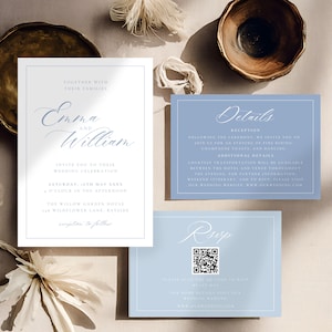 May include: Wedding invitation suite featuring a main invitation card with the names "Emma and William" in elegant script, and details cards in a soft blue hue. The suite includes RSVP and details cards, with decorative elements.