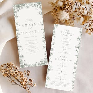 May include: Two wedding programs with floral borders. The programs feature the names "Sabrina and Daniel" and "The Wedding Party." The order of service and event details are printed on the programs. The programs are decorated with a floral design.