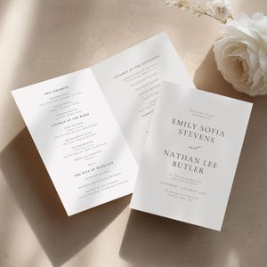 May include: Elegant wedding invitation suite featuring a tri-fold program and a separate card. The program details the ceremony, including readings and the rite of marriage. The invitation card displays the names Emily Sofia Stevens and Nathan Lee Butler.