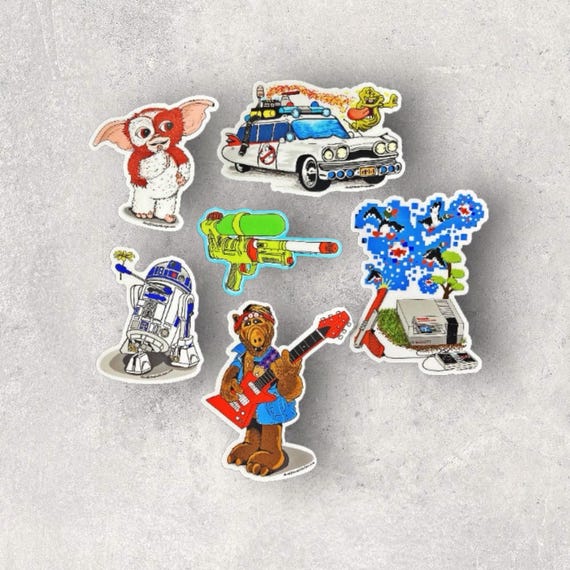 A Blast from the past! all of your favorite shots from the 80's all in one pack! These stickers are not only waterproof and scratch resistant but can hold up to any dishwasher.
Sticker Sizes:
Duck Hunt - Released 1984 - Sticker Size: 2.96" x 4"
Super Soaker 50 - Released 1989 - Sticker Size: 3" x 2.02"
R2-D2 - Released (Empire Strikes Back) 1980 - Sticker Size: 2.38" x 3
Alf - Released 1986 - Sticker Size: 3.26" x 4"
Ghoast Busters - Relased 1984 - Sticker Size: 4" x 2.49"
Gizmo - Released 1984 - Sticker Size: 2.71" x 3"