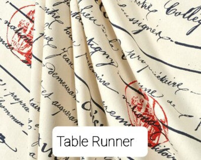 May include: A cream-colored table runner with a black and red print of handwritten text and a small red image. The text includes the words "The College" and "Demeuran".