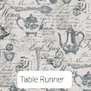 May include: A white table runner with a vintage tea party design. The pattern features teapots, cups, spoons, and handwritten text including "Menu", "Time", "Earl Grey", and "Tea".
