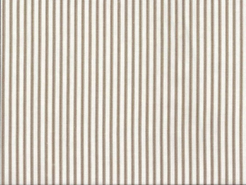May include: White fabric with thin brown stripes. The fabric has a subtle texture.