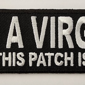 May include: Black embroidered patch with white text that reads "I'm a virgin but this patch is old".