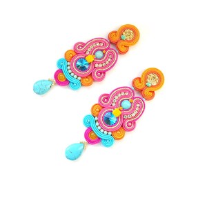 May include: A pair of colorful earrings with turquoise, pink, orange, and gold accents. The earrings are made of intricate woven threads and feature sparkling rhinestones.