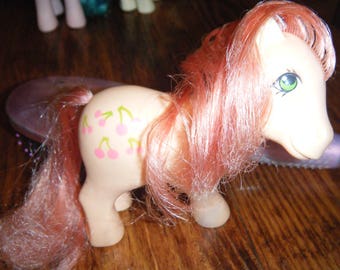 My Little Pony 1984 pony  with pink hair.."CHERRIES JUBILEE" .bit of discoloring on foot or may be age spot.otherwise good condition