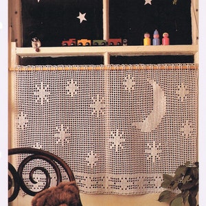 May include: White crocheted cafe curtain with a star and moon design. The curtain hangs in front of a window with a dark background and star cutouts. The text "Starry café curtain" is at the top. A teddy bear sits in front of the window.