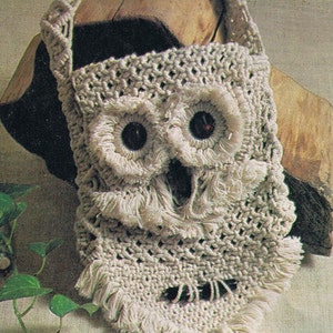 May include: A white crocheted owl-shaped bag with black eyes and fringe details. The bag has a long strap for carrying over the shoulder.