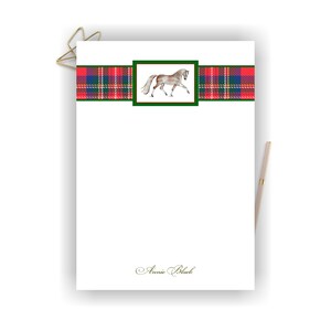 May include: White stationery with a red and green plaid border and a green square with a watercolor illustration of a horse. The text "Annie Black" is at the bottom of the page.