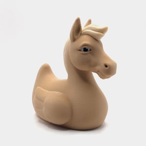 May include: A tan-colored hybrid figurine, blending the form of a duck and a horse. The sculpture features a horse's head with detailed eyes and a duck's body with wing details. The overall design is smooth with visible layer lines.