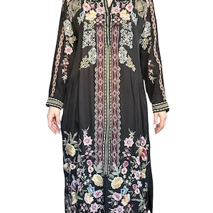 May include: A black long-sleeved midi dress featuring a central vertical panel with geometric patterns and colorful floral embroidery. The garment includes a collared neckline, button-down front, and intricate multi-colored flower motifs.