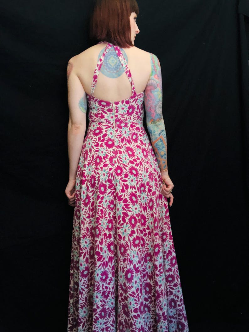 May include: A long, pink and white floral print maxi dress with a halter neckline and a low back.