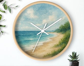 May include: Circular wall clock featuring a watercolour beach scene. The clock face depicts a blue sky with white clouds, turquoise water, and a sandy beach. It has a light wood frame and white hands.