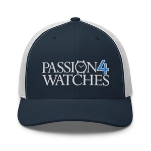 Puede incluir: Una gorra de camionero azul marino y blanca con el texto bordado "PASSION4 WATCHES" en blanco con un número 4 azul y un gráfico de esfera de reloj.