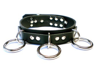 May include: Black leather choker with silver studs and four silver rings.