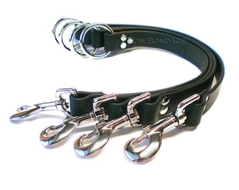 May include: Dark green leather leash with three silver-colored metal clasps and multiple metal rings. The text "ON BONDAGE" is visible on the leather. The leash is designed for a specific purpose.