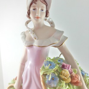 Vintage Royal Dux Figurine Of A Maiden with Baskets of Periwinkle and Roses