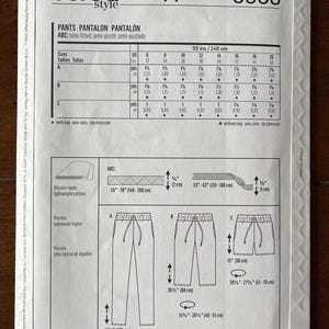 May include: A sewing pattern for pants, shorts, and a skirt. The pattern is for sizes 6-20 and includes instructions for cutting and sewing the garments. The pattern is printed on a white background with black text and illustrations.
