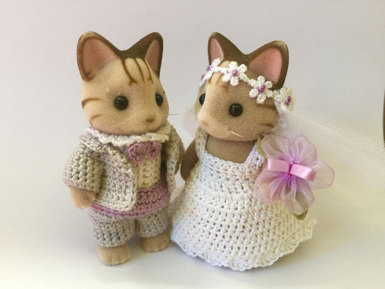 A groom and a bride Calico Critters squirrel set wearing wedding clothes.