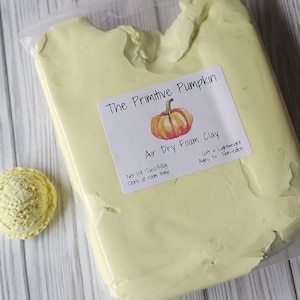 May include: A bag of yellow air dry foam clay with a label that reads "The Primitive Pumpkin Air Dry Foam Clay" with a small pumpkin illustration. The label also states "Net Wt 17oz/500g Store at room temp Soft Lightweight Ages 3+ Non-edible".