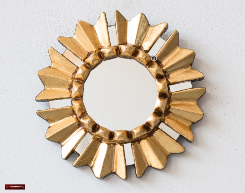 Gold Small Mirror 6-inch, hand-carved Peruvian bronze leaf art by Edmundo Contreras. Sunburst-style MDF frame with hand-cut mirror mosaic fragments on the outer edges. Elegant antique-style wall accent for a gallery wall, handcrafted in Peru. High-quality artisanal home decor.