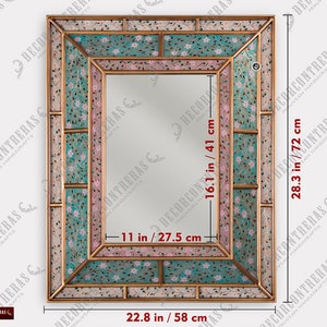 May include: A decorative mirror with a gold frame and a mosaic of pink and blue floral patterns. The mirror measures 28.3 inches by 16.1 inches.