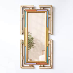 May include: A gold-toned rectangular mirror with a colorful geometric frame. The frame features a light blue, yellow, and pink design.