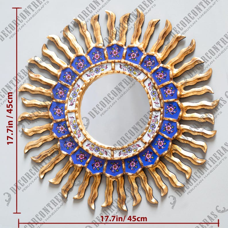 May include: A gold sunburst mirror with a blue and white tiled frame. The mirror is 17.7 inches in diameter.