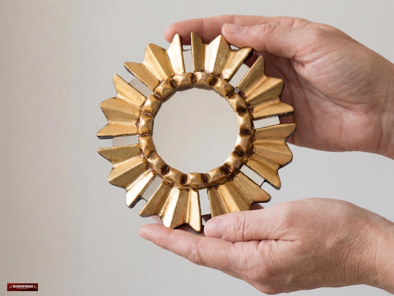 Gold Small Mirror 6", hand-carved Peruvian bronze leaf art by UNESCO artist Edmundo Contreras. Features a sunburst-style frame with hand-cut mirror mosaic pieces on the border. Antique-style round decorative mirror for gallery walls. Handcrafted in Peru, ships locally within USA