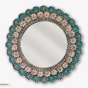 Hand painted Peruvian mirror, 23.6 inches across, with colonial turquoise florals painted behind the glass around a central round mirror. The round gold framed border is finished in antique gold over a black base and comes ready to hang above a bathroom vanity.