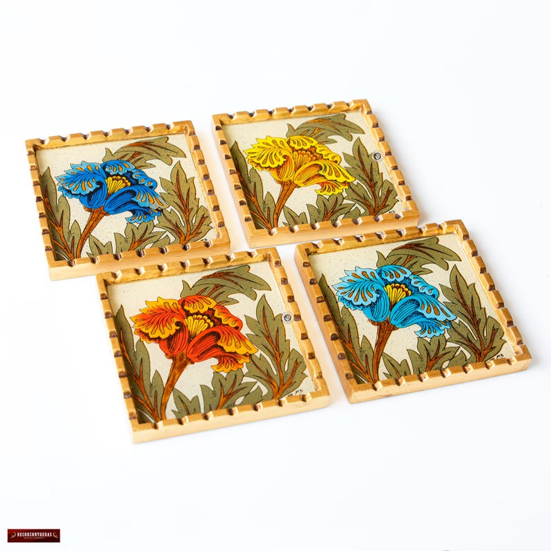 May include: Four square wooden coasters with gold trim and floral designs. Each coaster features a different colored flower with blue, yellow, orange, and red flowers.