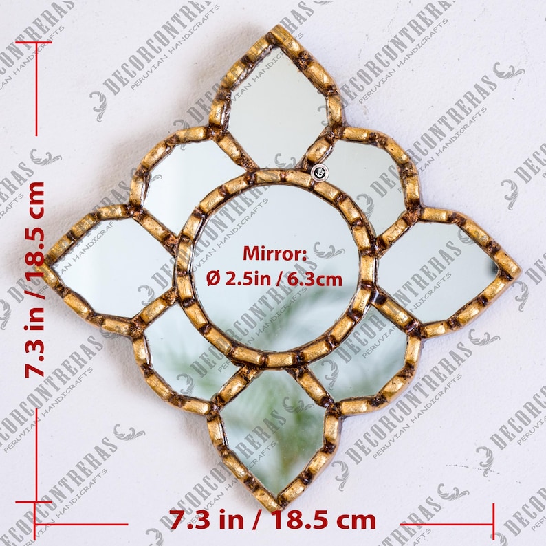 May include: A decorative wall mirror with a gold-colored frame and multiple mirrored sections. The mirror is shaped like a flower, measuring 7.3 inches (18.5 cm) in width and height. The central mirror is 2.5 inches (6.3 cm) in diameter.