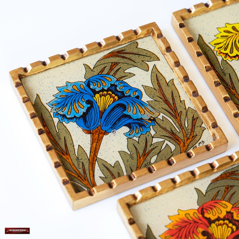 May include: Set of four coasters with a gold trim and a white background. Each coaster features a different floral design with blue, yellow, and orange flowers.