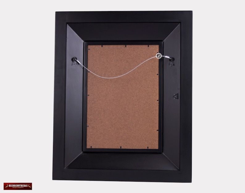 May include: Black picture frame with a brown mat and a wire hanging system on the back.