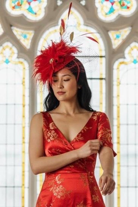 red dress with fascinator Kate Winslet wears her second statement fascinator in a month at Hong Kong races