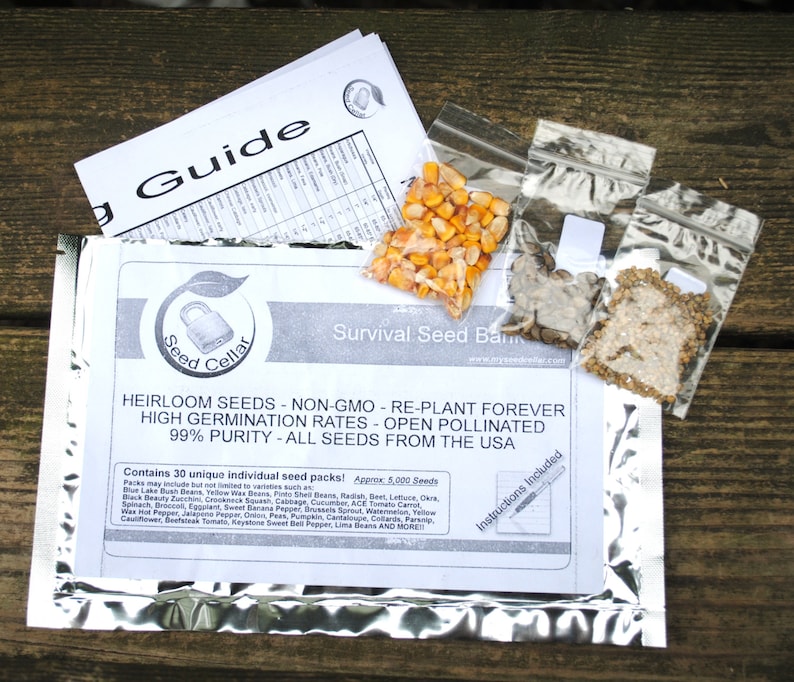 May include: A silver foil pouch containing a survival seed bank with a label that reads "Seed Cellar" and "Heirloom Seeds - Non-GMO - Re-Plant Forever". The pouch contains 30 unique individual seed packs with approximately 5,000 seeds. The label lists a variety of seeds including beans, lettuce, okra, zucchini, squash, cabbage, cucumber, tomato, carrot, cauliflower, pepper, jalapeno pepper, onion, peas, pumpkin, cantaloupe, and more.