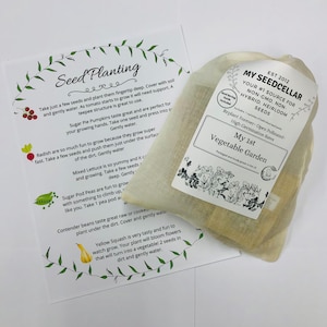 May include: A white cloth bag with a label that reads "My Seed Cellar" and "Your #1 Source for Non-GMO, Non-Hybrid, Heirloom Seeds". The bag contains small packets of seeds. The image also includes a white sheet of paper with instructions for planting seeds.