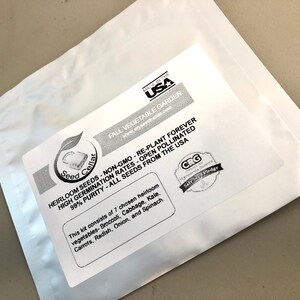 May include: A white resealable pouch with a label that reads "Seed Cellar" and "HEIRLOOM SEEDS NON-GMO - RE-PLANT FOREVER HIGH GERMINATION RATES - OPEN POLLINATED 99% PURITY - ALL SEEDS FROM THE USA". The label also lists the contents of the pouch: "This kit consists of 7 chosen heirloom vegetables - Broccoli, Cabbage, Kale, Carrots, Radish, Onion, and Spinach."