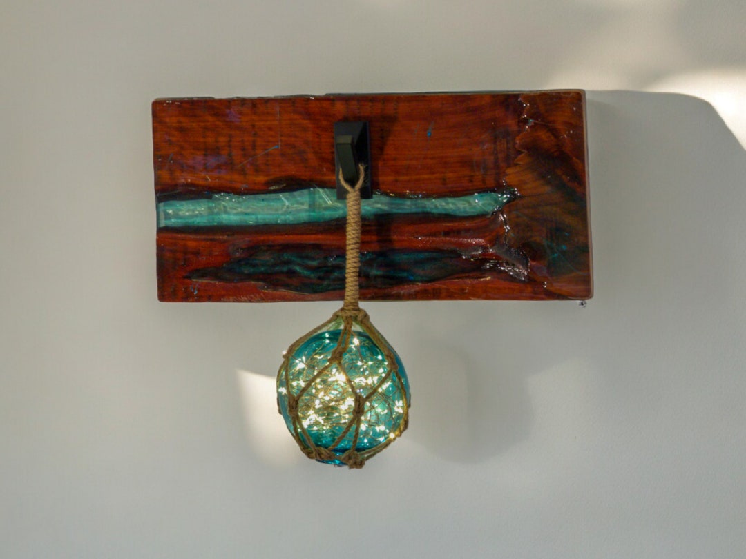 Image showcasing Japanese Glass Fishing Float Wall Sconce on a Cedar Live Edge Resin ...