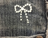 A pack of 10 White Flocked Velvet Iron-On Transfers Bow Motif 2.5cm Long Denim Patch Embellishment
