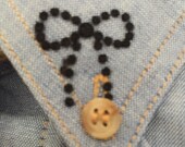 A pack of 10 Black Flocked Velvet Iron-On Transfers Bow Motif 2.5cm Long Denim Patch Embellishment