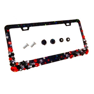 May include: Black license plate frame with red and clear rhinestones. The frame comes with four screws and four caps.