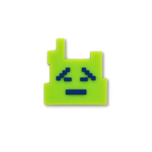 May include: A lime green, pixelated charm shaped like a retro video game character. The charm features a blue face and a small antenna. The design is simple and reminiscent of 8-bit graphics, perfect for a nostalgic accessory.