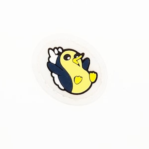 May include: A yellow penguin with black wings and a white belly is on a white background. The penguin is smiling and has its wings spread out.