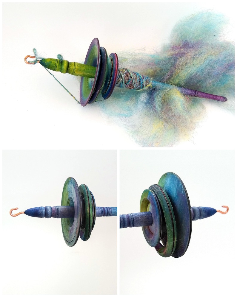 May include: A hand spindle with a wooden shaft and colorful, graduated whorls. The spindle has a copper hook and is shown with a cloud of pastel-colored fiber. The whorls are painted in shades of green, blue, and purple.