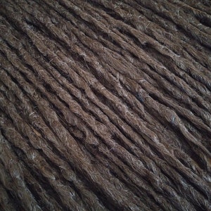 May include: A close-up of a bundle of brown synthetic dreadlocks.